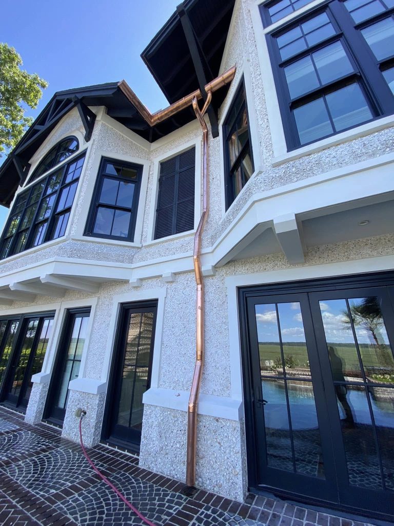 Custom copper gutter installation on a Bluffton SC home by GutterXperts showing handcrafted joints and downspouts