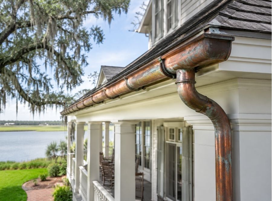 Copper gutters aging naturally on a luxury May River Bluffton SC waterfront home with Spanish moss and Lowcountry architecture